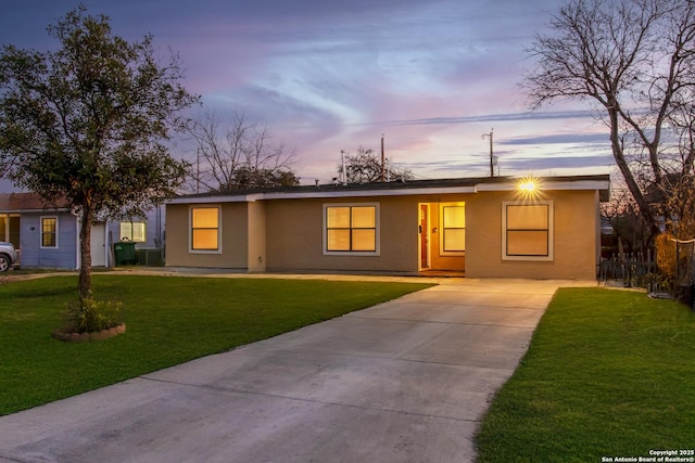 ranch-style house featuring a lawn