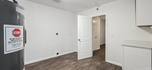 interior space featuring electric dryer hookup and dark hardwood / wood-style flooring