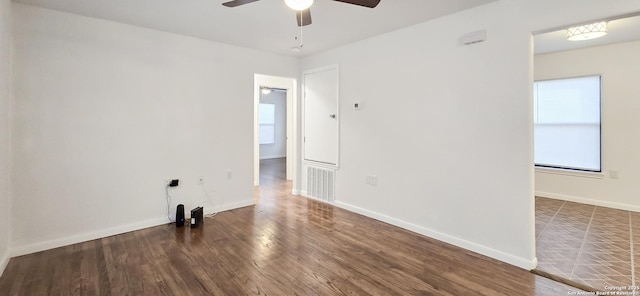 spare room featuring dark hardwood / wood-style floors and ceiling fan