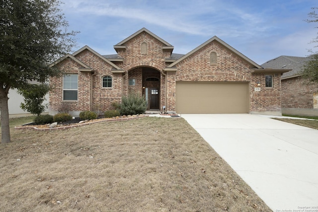 view of front of home with a garage and a front lawn