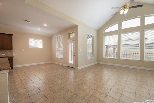 unfurnished living room with lofted ceiling, light tile patterned floors, a wealth of natural light, and ceiling fan