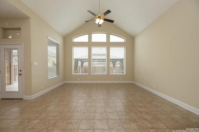 tiled spare room with ceiling fan and vaulted ceiling