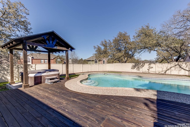 view of pool with a hot tub, a gazebo, and a deck