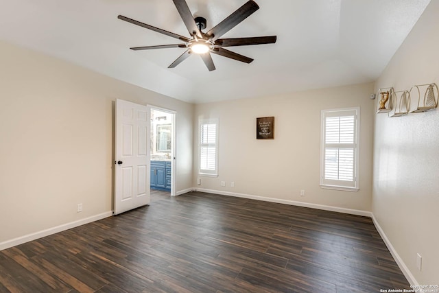 spare room with dark hardwood / wood-style floors, a wealth of natural light, and ceiling fan