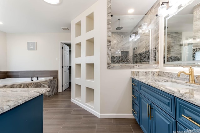 bathroom featuring built in shelves, vanity, and independent shower and bath