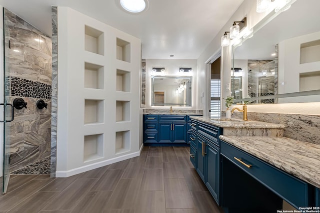 bathroom with vanity, an enclosed shower, and built in features