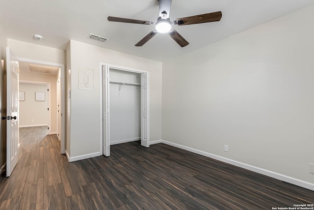 unfurnished bedroom with dark hardwood / wood-style floors, a closet, and ceiling fan