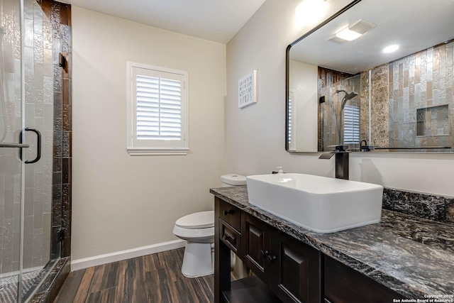 bathroom with vanity, wood-type flooring, toilet, and walk in shower