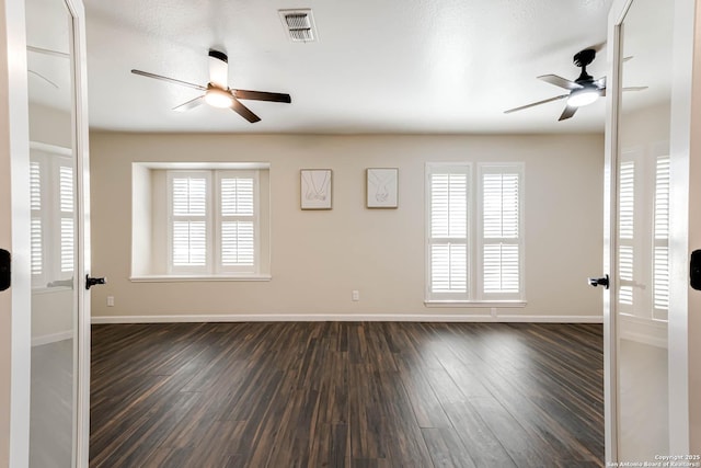 spare room with dark hardwood / wood-style floors, ceiling fan, and french doors