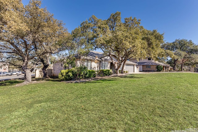 view of front of house with a garage and a front lawn