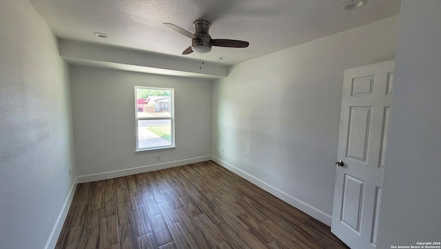 empty room featuring ceiling fan and dark hardwood / wood-style floors