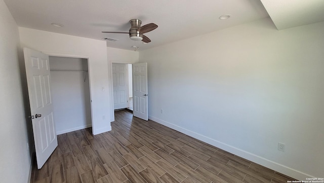 unfurnished bedroom with ceiling fan and a closet