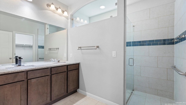 bathroom featuring vanity, tile patterned floors, and a shower with door