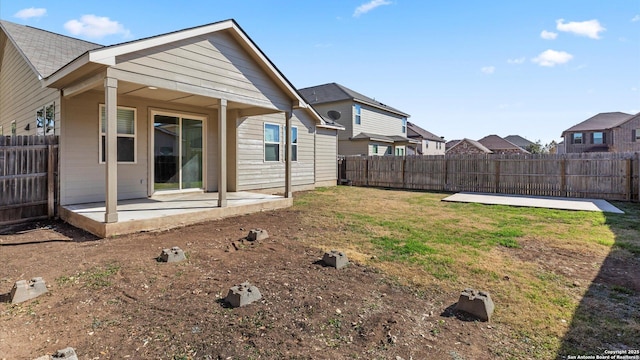 back of property with a patio and a lawn