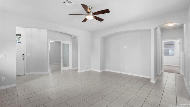 spare room with a healthy amount of sunlight and ceiling fan