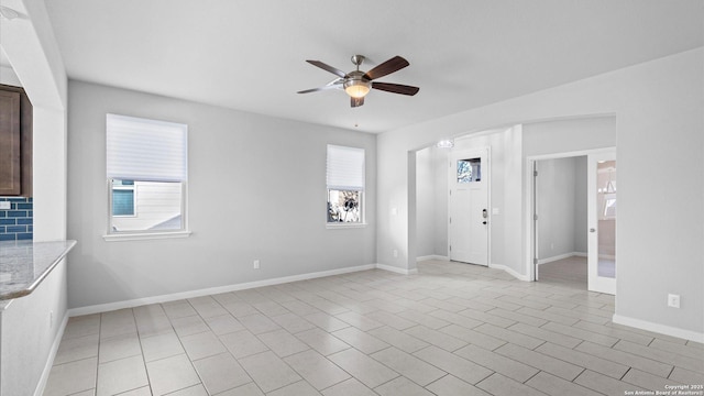 spare room with light tile patterned floors and ceiling fan