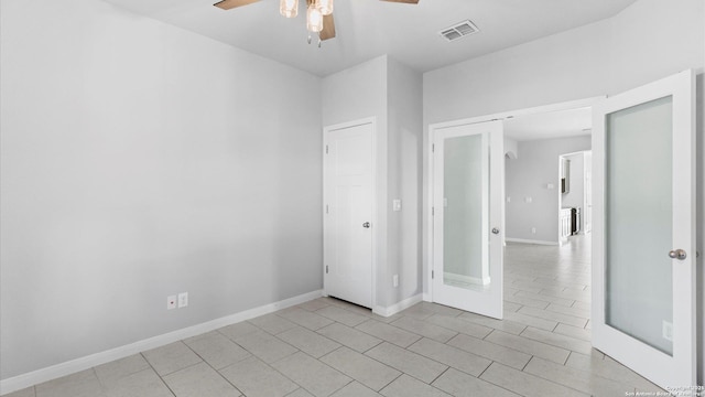 tiled empty room with ceiling fan