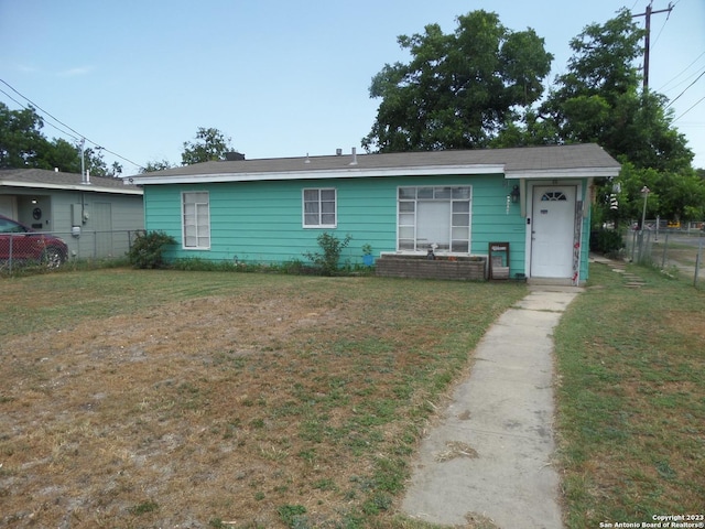 ranch-style home featuring a front yard