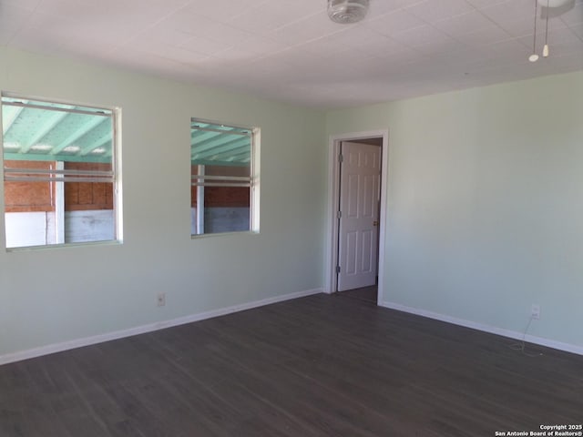 empty room with dark wood-type flooring