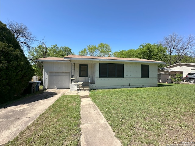 single story home featuring a garage and a front yard