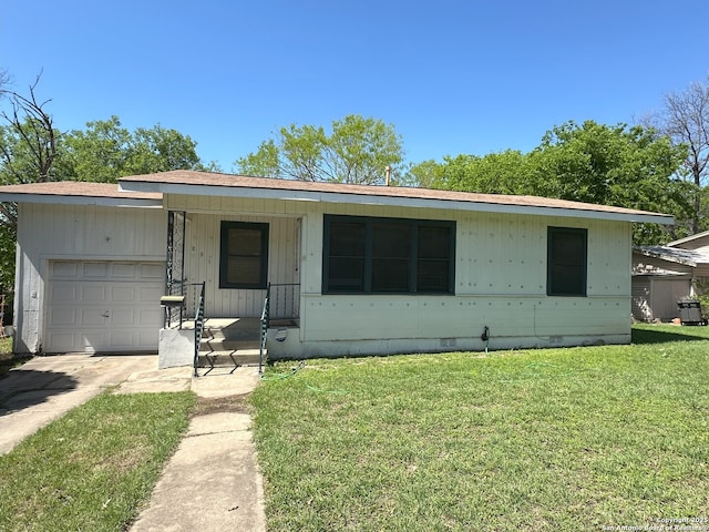 single story home with a garage and a front yard