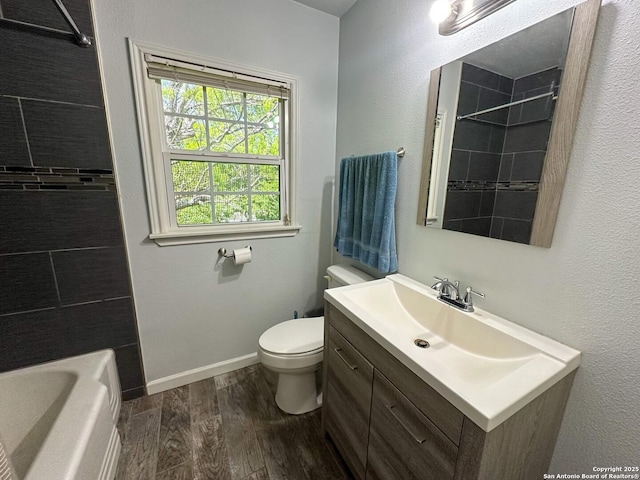 bathroom with vanity, toilet, and hardwood / wood-style floors