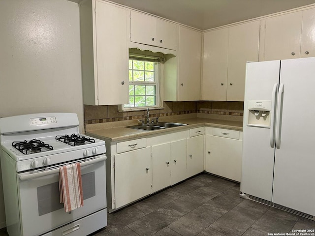 kitchen featuring sink, white appliances, decorative backsplash, and white cabinets