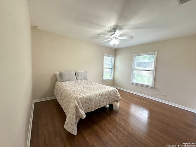 bedroom featuring dark hardwood / wood-style flooring and ceiling fan