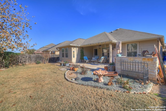 back of property featuring a patio, a bar, ceiling fan, and a lawn