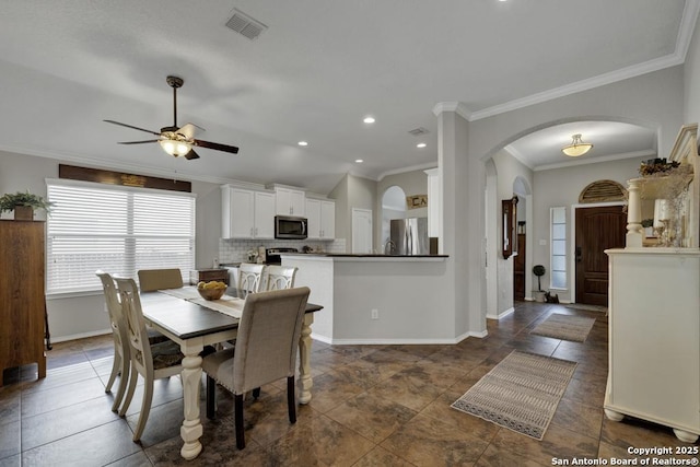 dining room with ornamental molding and ceiling fan