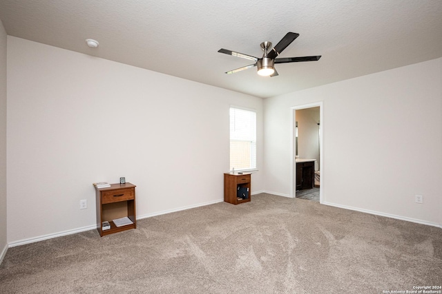 spare room with ceiling fan, carpet flooring, and a textured ceiling