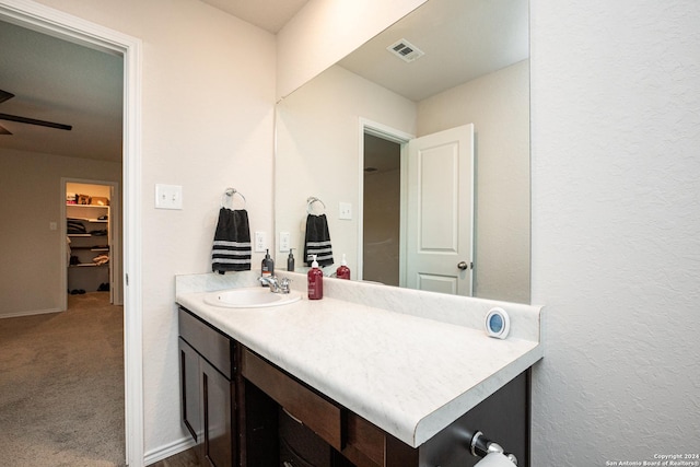 bathroom featuring ceiling fan and vanity