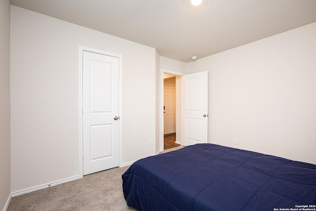 bedroom featuring carpet and a textured ceiling