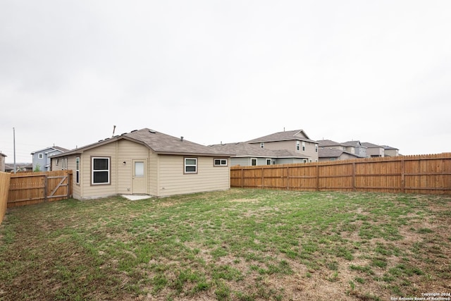 back of property featuring a lawn