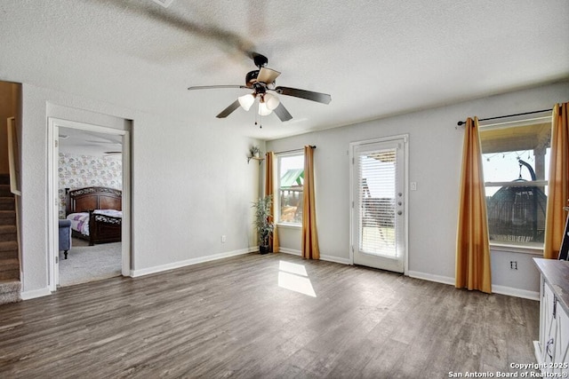 empty room featuring hardwood / wood-style floors, a textured ceiling, and ceiling fan