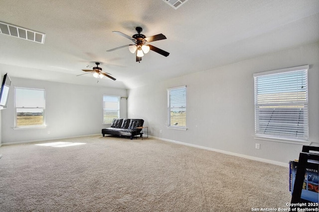 living area with ceiling fan and carpet flooring