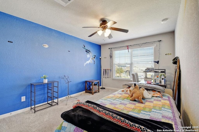 carpeted bedroom with ceiling fan and a textured ceiling