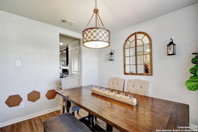 dining room with wood-type flooring