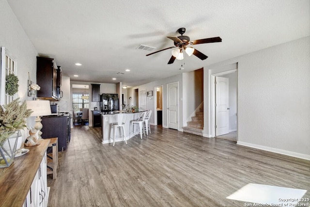 living room featuring ceiling fan and wood-type flooring