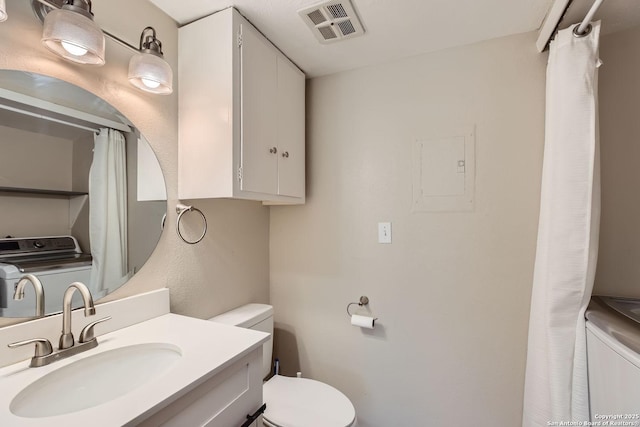 bathroom with toilet, vanity, and washer / clothes dryer