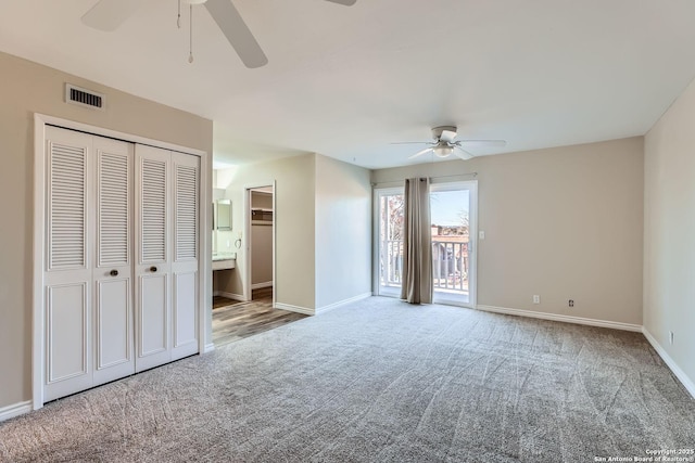 unfurnished bedroom featuring access to outside, a closet, ceiling fan, and carpet