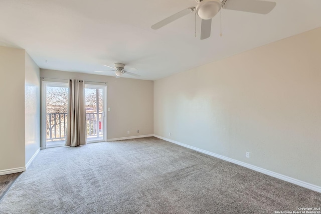 carpeted spare room featuring ceiling fan