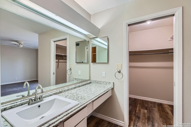 bathroom with vanity, hardwood / wood-style flooring, and ceiling fan