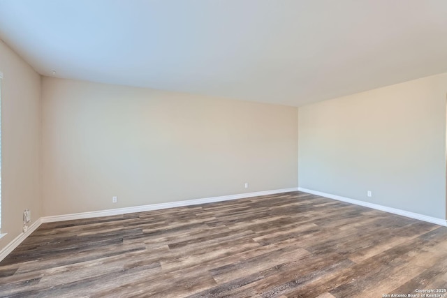 unfurnished room featuring dark wood-type flooring