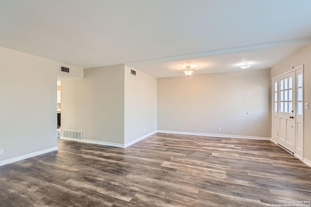 empty room with dark hardwood / wood-style flooring