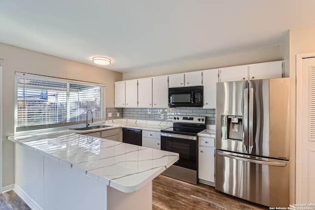 kitchen with tasteful backsplash, black appliances, sink, white cabinets, and kitchen peninsula