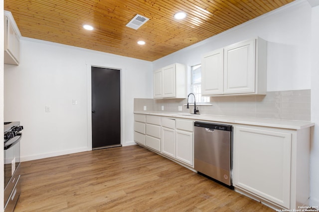 kitchen with tasteful backsplash, sink, stainless steel appliances, and white cabinets