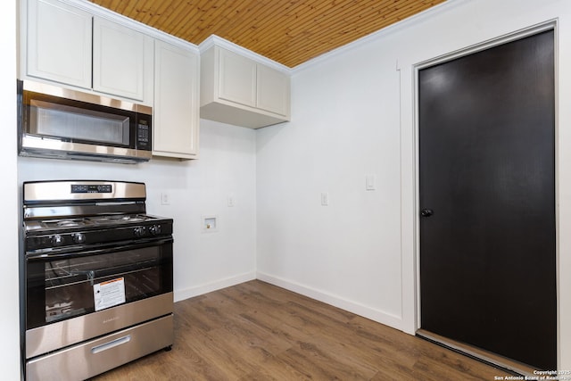 kitchen with white cabinetry, ornamental molding, wood ceiling, stainless steel appliances, and dark wood-type flooring