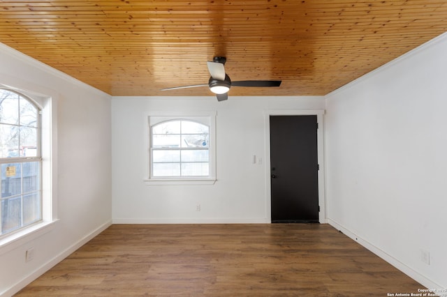 spare room featuring wood ceiling, ornamental molding, wood-type flooring, and ceiling fan