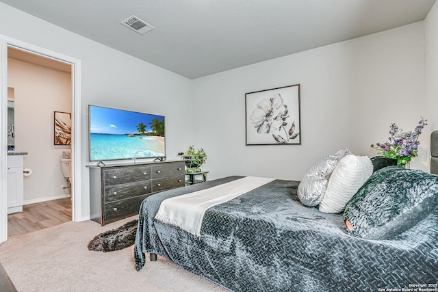 carpeted bedroom with ensuite bathroom